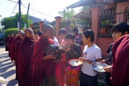 Joining the monks collecting the alms